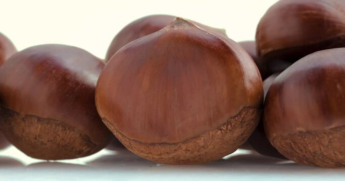 Autumn delicacies, chestnuts in front of white background