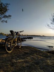 bike on the beach at sunset