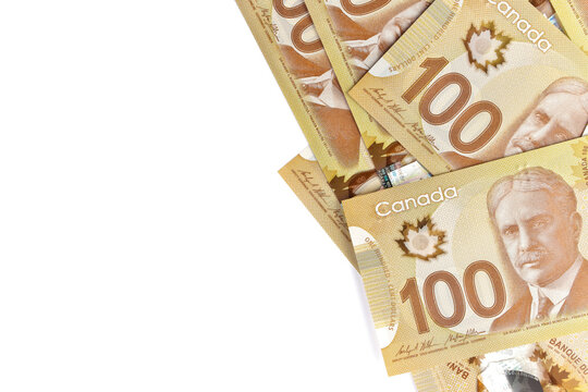 Directly Above Image of Crisp Canadian 100 One Hundred Dollar Bills on a White Background