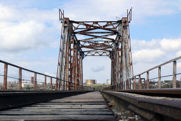 Fototapeta na wymiar Metal bridge over the river, railway bridge