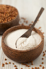 buckwheat flour on white wooden surface