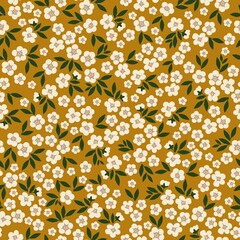 Beautiful vintage pattern. White flowers, dark green leaves. Mustard background. Floral seamless background. An elegant template for fashionable prints.