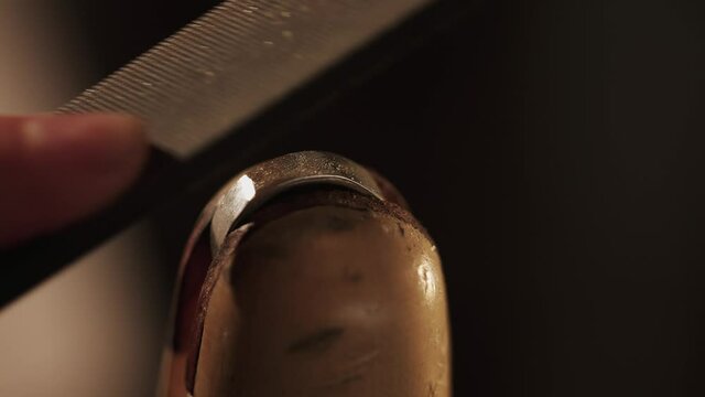 Jeweler creating new jewelry . Master goldsmith working process . Slow motion of experienced goldsmith working on a handmade jewelry bracelet . 