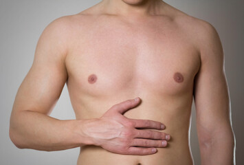 Obraz premium Stomach pain. The man has a stomach ache