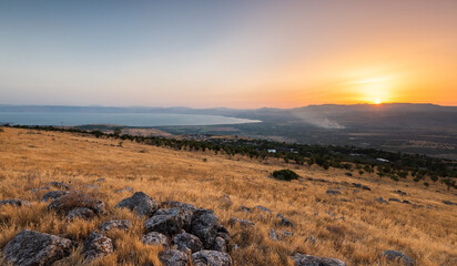 Sunset behind the Galilee mountains and the north part of the sea of Galilee as seen from the Golan heights in Israel.