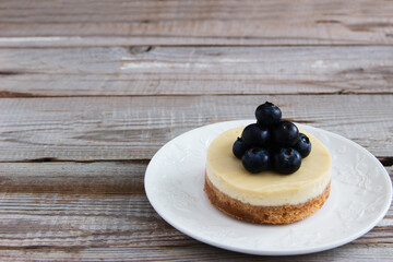 American Cheesecake with blueberry on a stand.