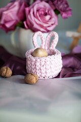 Fototapeta na wymiar Cozy elegant festive table decor for Easter in a light tone. handmade macrame products, eggs.