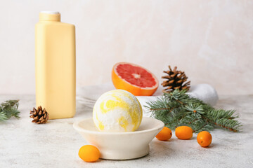Composition with bath bomb, kumquat and fir branch on light background
