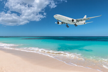 Airplane landing over beautiful beach. - obrazy, fototapety, plakaty
