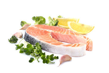 Salmon fish on the white background with fresh  vegetables  and lemon.  Salmon steak isolated.