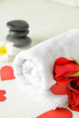 Obraz na płótnie Canvas Beautiful roses and towel for Valentine's Day celebration on light background, closeup