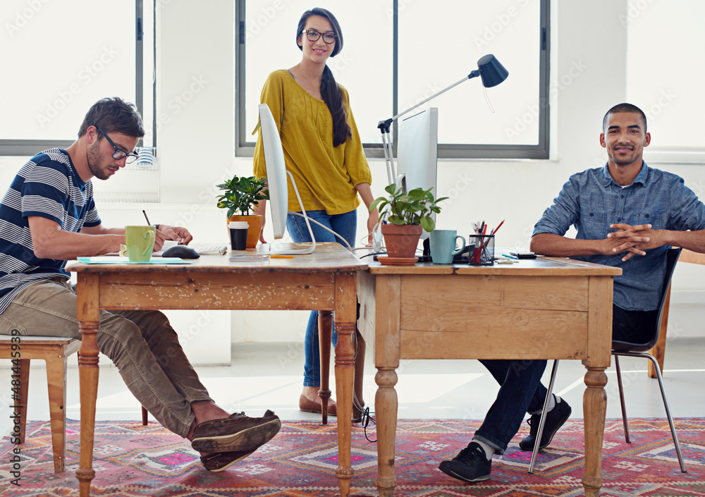 Aufkleber getting down to designing. shot of a group of creative professionals working in an office.