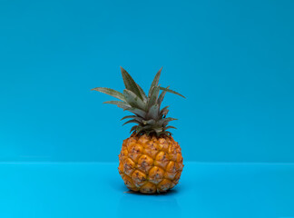 Pineapple on a blue background. tropical fruit. Proper nutrition. Flat lay, copy space.