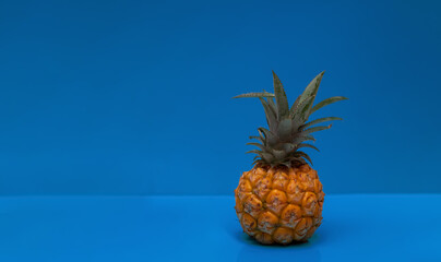 Pineapple on a blue background. tropical fruit. Proper nutrition. Flat lay, copy space.