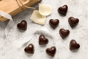 Tasty heart-shaped candies on light background