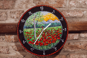 painted wall clock caught on a wooden plank