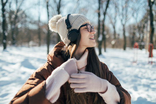 Pretty young woman enjoy winter day with music