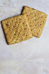 Bread made of square slices of assorted seeds, on a stone base