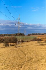 High voltage power tower and beautiful nature landscape in the Czech countryside. Electricity distribution concept. Green deal. Clean energy.