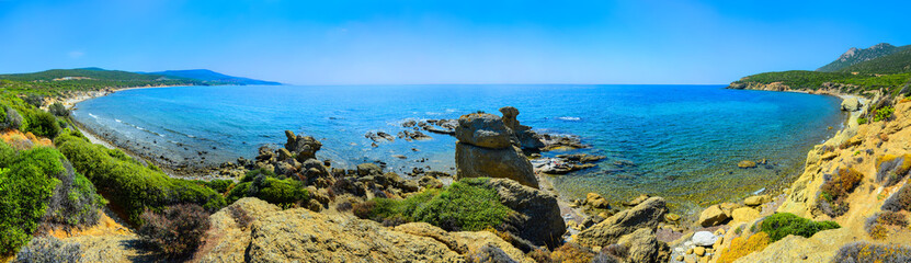 Sea landscape panorama - rocky shore, waves and blue clear water