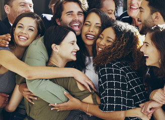 More than colleagues. Cropped shot of a group of happy businesspeople standing in their workplace lobby.