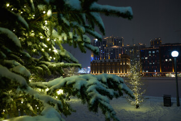 view of the night winter city across the frozen river