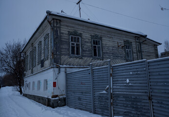 old wooden house in winter city