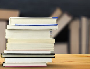 Stack of books on the table in the library background