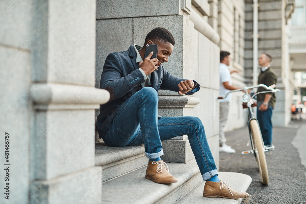 Poster No greater business tool than time. Shot of a young businessman using a smartphone and checking the time against an urban background.