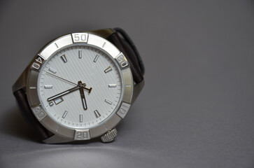 Men's watch made of metal on a gray background. - Powered by Adobe