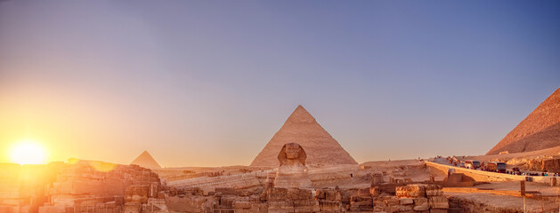 Banner Main tourist view famous wonder of world Sphinx and pyramids Giza, Egypt sunset sky - obrazy, fototapety, plakaty