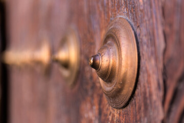 Metal rivets on old wooden door