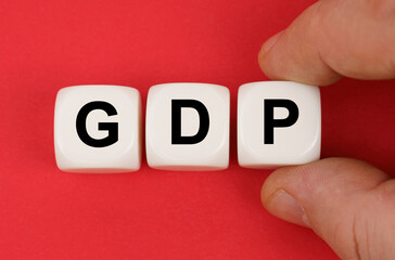 On the red surface, white cubes with the inscription - GDP