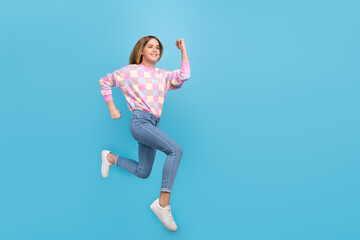 Obraz premium Full length body size view of attractive motivated cheerful girl jumping running marathon isolated over bright blue color background