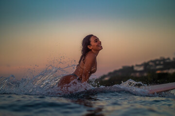 Surfing woman wave splash