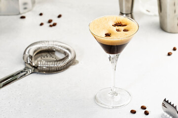 Espresso martini alcoholic cocktail with vodka, coffee liqueur, syrup and ice, white background,...
