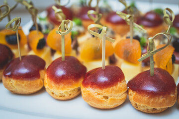 Catering table, beautifully decorated banquet with variety of with different food snacks and appetizers on corporate birthday party event or wedding celebration, seafood, canape, delicatessen setting