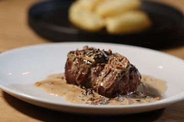 Steak with sauce on with plate