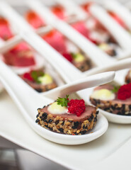 Catering table, beautifully decorated banquet with variety of with different food snacks and appetizers on corporate birthday party event or wedding celebration, seafood, canape, delicatessen setting