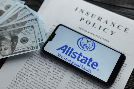 New York, USA - January 19. 2022: Smartphone with logo allstate insurance company on paper policy and money currency