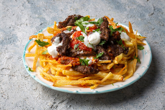 Turkish food; Cokertme Kebab - Beef meat kebab with yoghurt and french fries