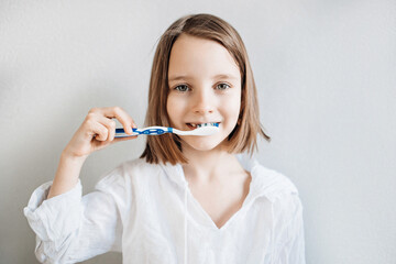 Girl brushes her teeth, dental care since childhood, a visit to the dentist