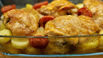 chicken legs lie in a glass pan in the kitchen