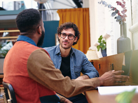 UK, London, Two Businessmen Talking In Creative Studio