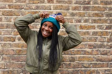 Portrait of mature woman in front of brick wall