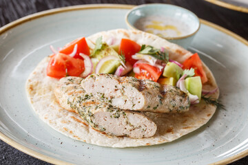 Fried chicken kebab with shrimp. Served with flatbread, salad and white sauce.