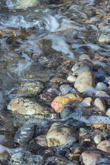 sea waves splashing on a hot summer pebble beach
