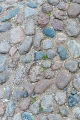 fragment of a stone path made of stones of different sizes and colors on the territory of the Pskov Kremlin, Russia