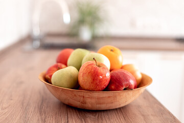 Healthy food at home. healthy fruits: red green apples and oranges at the table in the kitchen. Healthy food baby dieting concept. selective focus