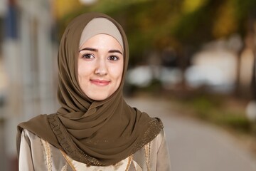 beautiful woman in hijab smiling on outdoor background